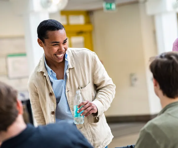 Student skrattar. Foto.